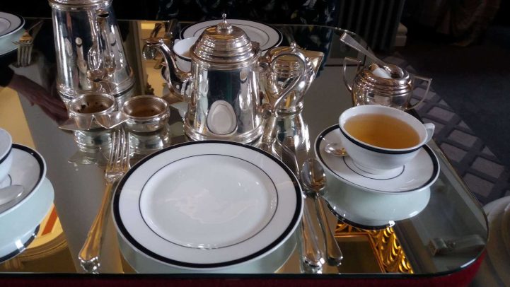 Tea served from a silver tea pot.